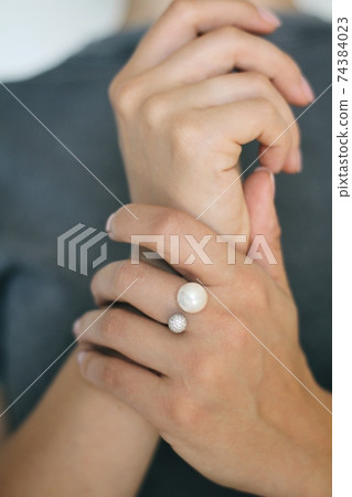 Tender jewerly on female hand, close up shot Tender jewerly on female hand, close up shot 74384023
