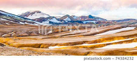 Rainbow mountains and fields of snow 74384232