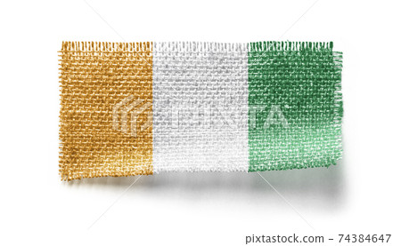 Cote dIvoire flag on a piece of cloth on a white background Cote dIvoire flag on a piece of cloth on a white background 74384647