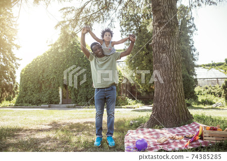 African american man spending time in the park with his daughter and looking happy 74385285