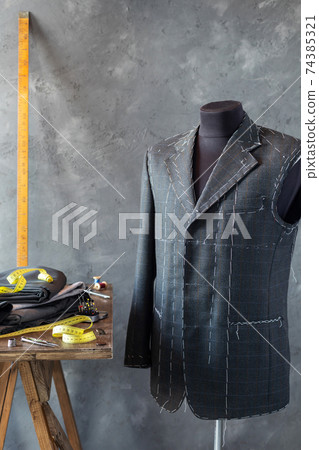 suit jacket on male tailor mannequin and sewing tools, 74385321