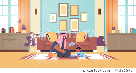 arab father playing with little son at home fatherhood parenting concept dad spending time with his kid arab father playing with little son at home fatherhood parenting concept dad spending time with his kid 74385573