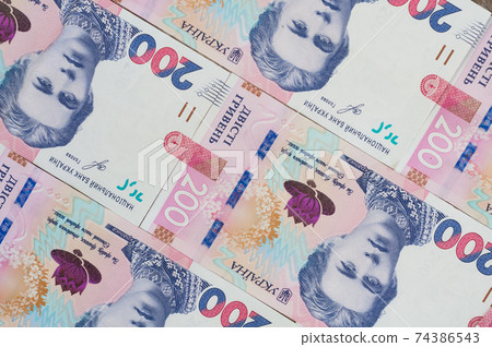 Paper money, Ukrainian hryvnia in denomination 100 hryvnia, new money, background with scattered banknotes Paper money, Ukrainian hryvnia in denomination 100 hryvnia, new money, background with scattered banknotes 74386543
