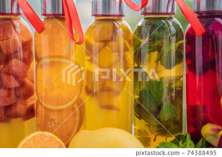Cambucha with various fruits arranged in the form of a rainbow. Homemade fermented raw kombucha tea with different flavorings. Healthy natural probiotic flavored drink. LGBT Cambucha with various fruits arranged in the form of a rainbow. Homemade fermented raw kombucha tea with different flavorings. Healthy natural probiotic flavored drink. LGBT 74388495
