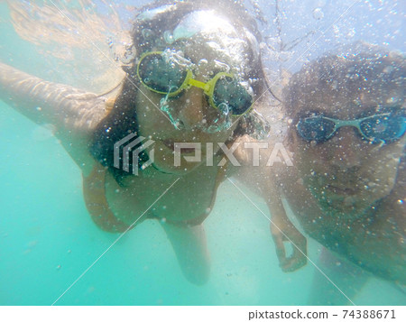 Couple having fun underwater in the sea 74388671