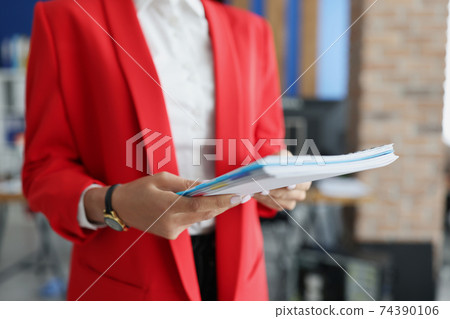 Female hands hold folder with financial documents Female hands hold folder with financial documents 74390106