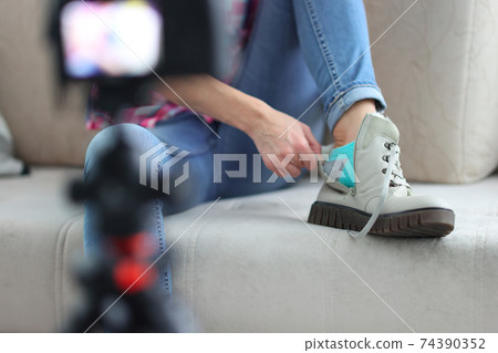 Blogger is filming an overview of boots 74390352