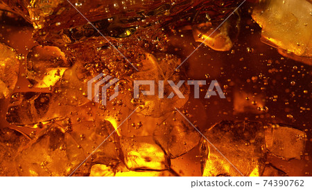 Detail of cola or alcoholic drink with ice cubes Detail of cola or alcoholic drink with ice cubes 74390762