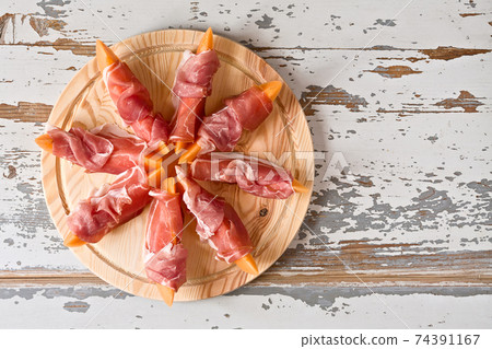 Italian food with prosciutto and melon Italian food with prosciutto and melon 74391167