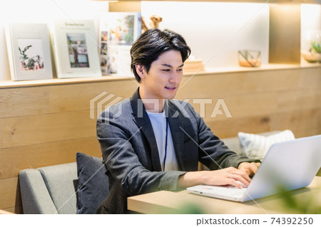 A businessman working in a cafe 74392250
