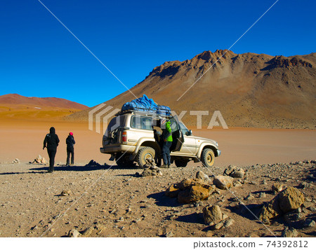 Off-road SUV with tourist on Altiplano 74392812