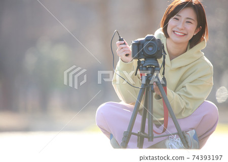 A woman taking a picture 74393197