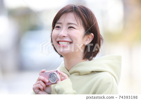 A woman taking a picture A woman taking a picture 74393198