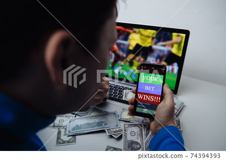 Man watching football match online broadcast on his laptop and celebrate after winning result Man watching football match online broadcast on his laptop and celebrate after winning result 74394393