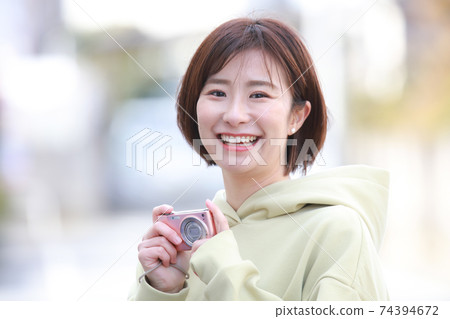 A woman taking a picture A woman taking a picture 74394672