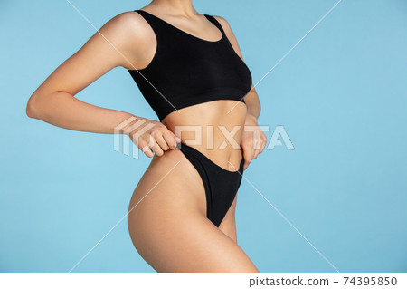 Beautiful body of young caucasian woman isolated on blue studio background 74395850