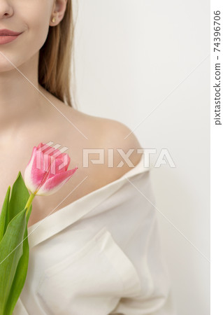 Young woman with one tulip Young woman with one tulip 74396706