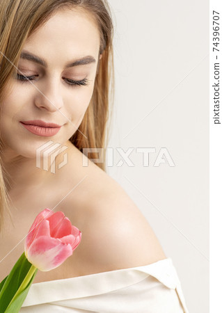 Young woman with one tulip Young woman with one tulip 74396707