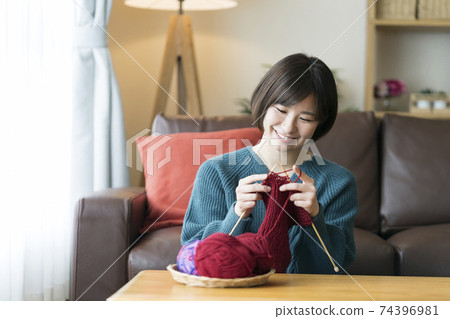 A young lady knitting A young lady knitting 74396981