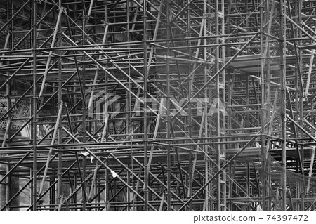 Complicated scaffolding consisting of many poles 74397472