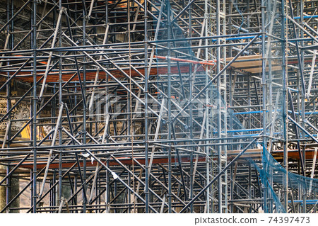 Complicated scaffolding consisting of many poles  74397473