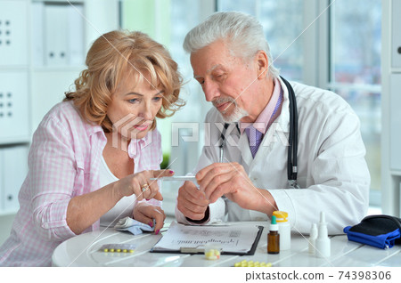 Portrait of senior doctor with elderly patient Portrait of senior doctor with elderly patient 74398306