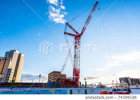 Tower crane under construction / evening 74399186