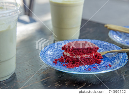 Chocolate soft cake with brass spoon on ceramic plate, focus selective. 74399322