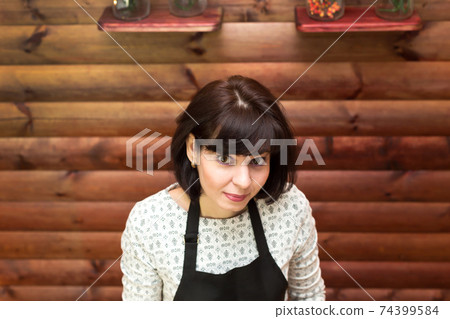 The brunette woman looks up. Copy space 74399584