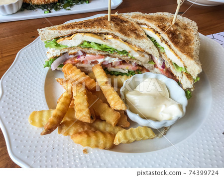 Chicken sandwich and French fries Chicken sandwich and French fries 74399724