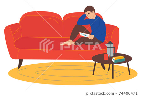 Man sitting on the sofa correspondence surfing the Internet. Social media network communication 74400471