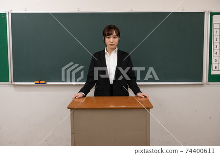 Teacher in front of the blackboard 74400611