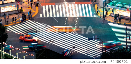 People and traffic cross the famous scramble intersection in Shibuya, Tokyo, Japan People and traffic cross the famous scramble intersection in Shibuya, Tokyo, Japan 74400701