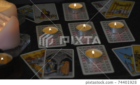 Defocused assortment of Tarot inspired cards 74401928