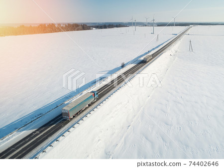 Winter highway with cargo lorry Winter highway with cargo lorry 74402646