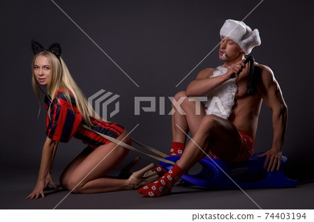 Couple in erotic Xmas costumes enjoying BDSM game 74403194