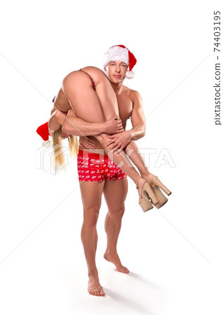 Sexy couple in erotic Xmas costumes having fun Sexy couple in erotic Xmas costumes having fun 74403195