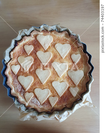 Homemade shortcrust cake decorated with heart shape cookies. Wooden rustic background. Pastry, pie, tart. Valentine's Day, greeting card, Copy space, top view, love 74403197