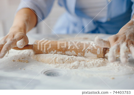 Beautiful lady cook the dough for cookies 74403783