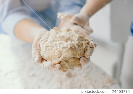 Beautiful lady cook the dough for cookies 74403784