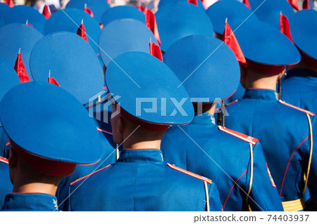 military parade in a city, soldiers in full dress uniforms ordered in parade formation 74403937