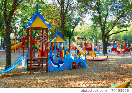children's playground in a city Park early in the morning, various swings and carousels 74403966