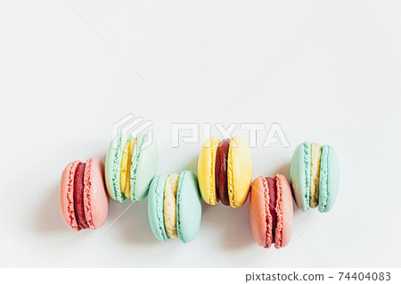 Sweet almond colorful pastel pink blue yellow green macaron or macaroon dessert cake isolated on white background. French sweet cookie. Minimal food bakery concept. Flat lay top view, copy space 74404083