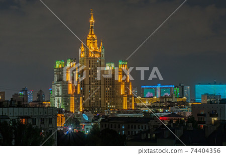 Moscow night. High-rise building on Kudrinskaya square near the Barrikadnaya metro station. Architecture of Soviet time 74404356