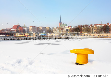 Szczecin waterfront with frozen Odra River in winter, Poland. Szczecin waterfront with frozen Odra River in winter, Poland. 74404816