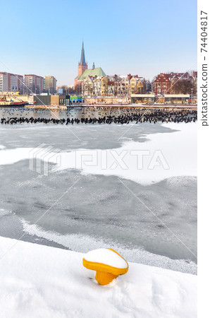 Szczecin waterfront with frozen Odra River in winter, Poland. Szczecin waterfront with frozen Odra River in winter, Poland. 74404817