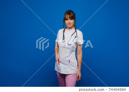 Young doctor woman with stethoscope isolated on blue background. Young doctor woman with stethoscope isolated on blue background. 74404984