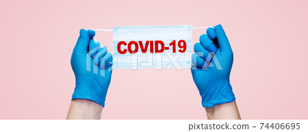 Hands in medical gloves hold medical protective mask. Hands in medical gloves hold medical protective mask. 74406695