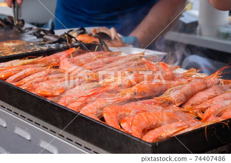 Process of cooking fresh red langoustine shrimps, prawns on grill - street food Process of cooking fresh red langoustine shrimps, prawns on grill - street food 74407486