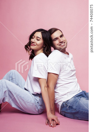 young cheerful caucasian couple together having fun on pink background, guy ang girl modern relationship, lifestyle people concept young cheerful caucasian couple together having fun on pink background, guy ang girl modern relationship, lifestyle people concept 74408075